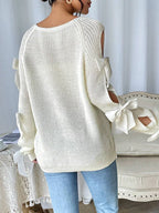 Modischer Strickpullover mit Schleifendetails, durchbrochenen Raglanärmeln und Rundhalsausschnitt im minimalistischen Stil