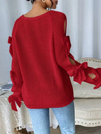 Modischer Strickpullover mit Schleifendetails, durchbrochenen Raglanärmeln und Rundhalsausschnitt im minimalistischen Stil