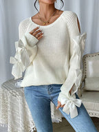 Modischer Strickpullover mit Schleifendetails, durchbrochenen Raglanärmeln und Rundhalsausschnitt im minimalistischen Stil
